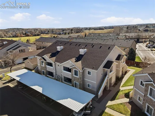 an aerial view of a house with a yard
