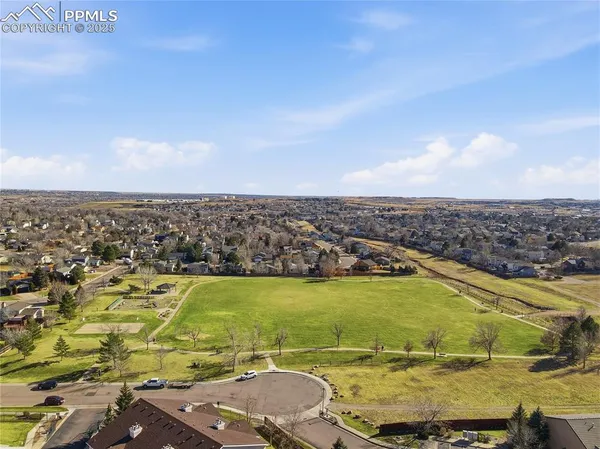 an aerial view of residential house and green space