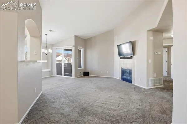a view of a kitchen with refrigerator and a sink