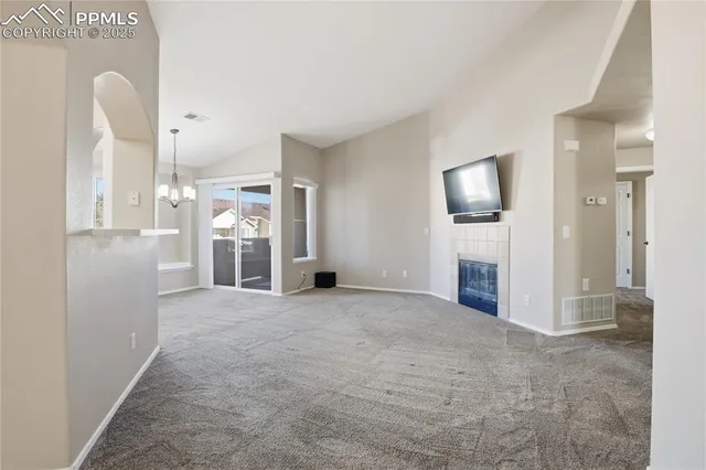 a view of a kitchen with refrigerator and a sink