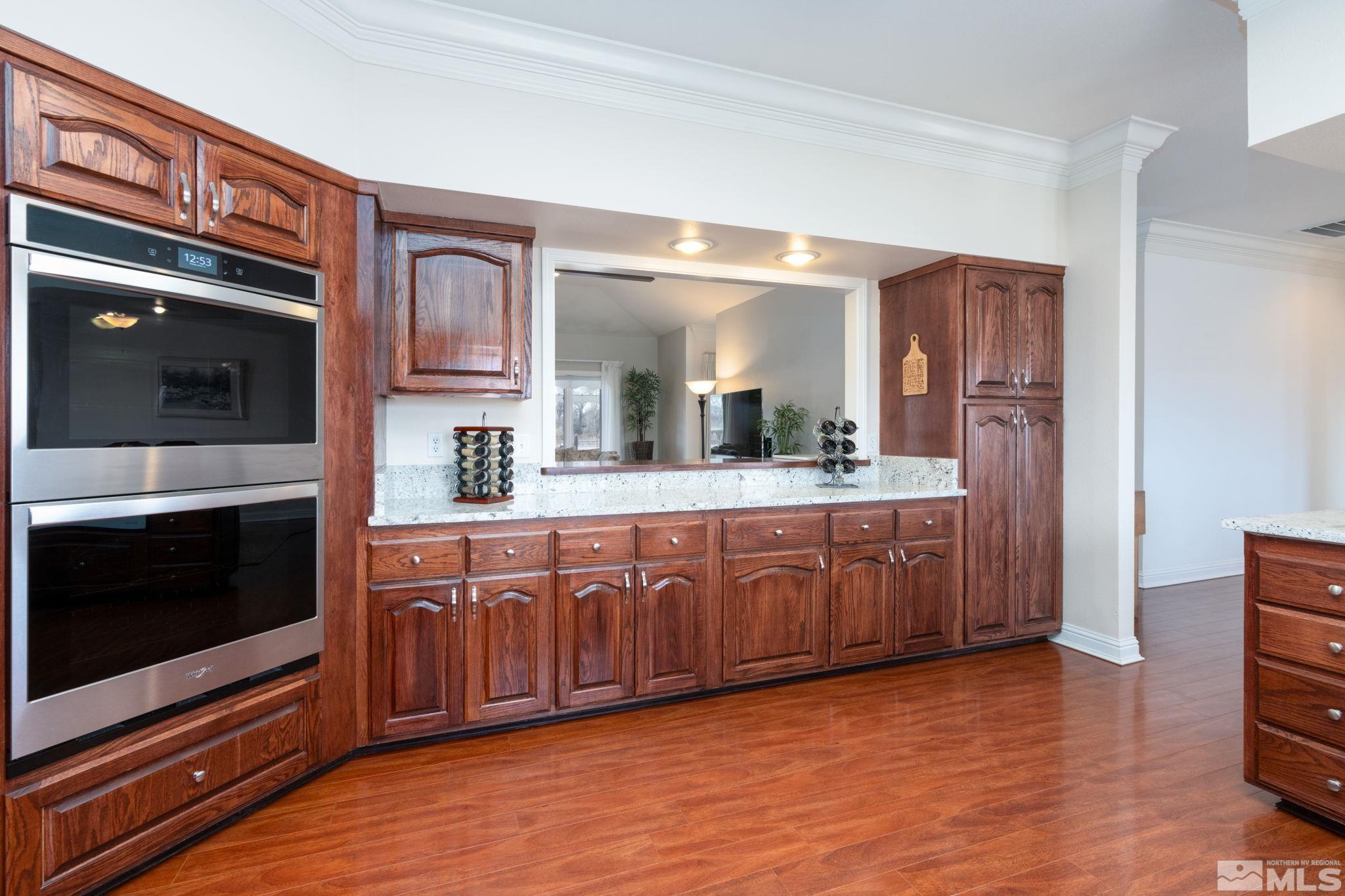 615 Carson River Drive Fallon, NV 89406 - Photo 12 of 40 a large kitchen with stainless steel appliances granite countertop a stove a sink and a microwave