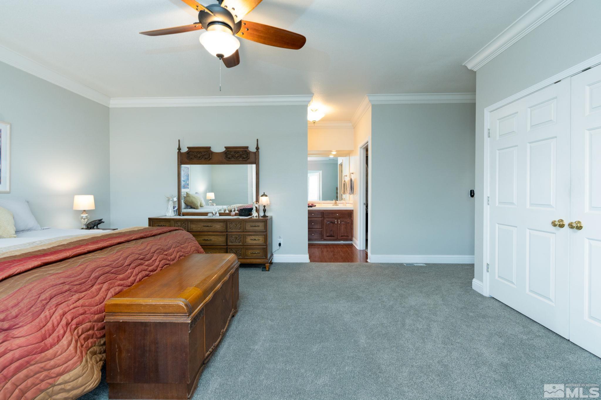 615 Carson River Drive Fallon, NV 89406 - Photo 17 of 40 a bedroom with a bed and a chandelier