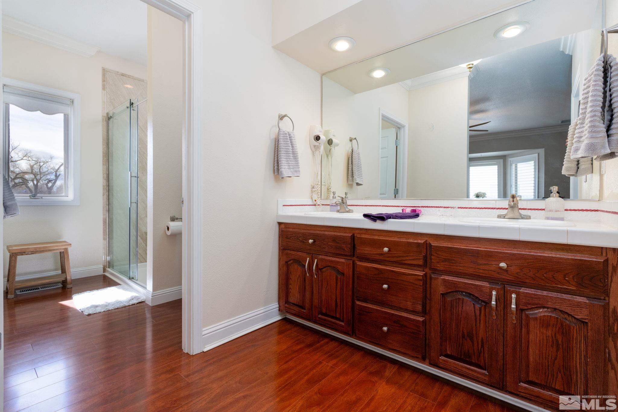 615 Carson River Drive Fallon, NV 89406 - Photo 20 of 40 a bathroom with a granite countertop double vanity sink and mirror