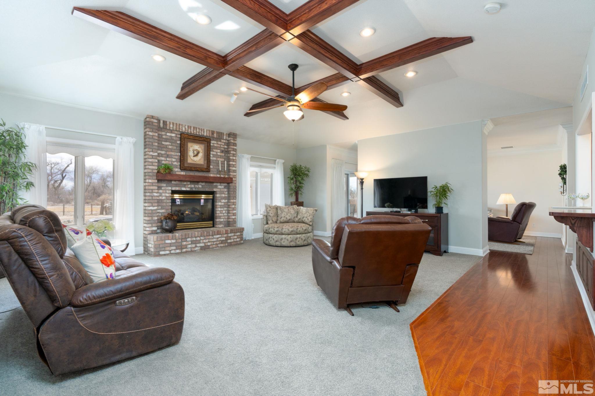 615 Carson River Drive Fallon, NV 89406 - Photo 4 of 40 a living room with furniture a fireplace and a ceiling fan