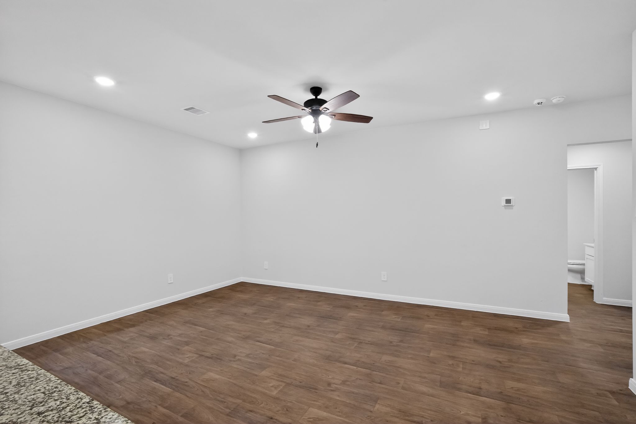 206 Addison Place Lockhart, TX 78644 - Photo 4 of 25 wooden floor in an empty room with a window