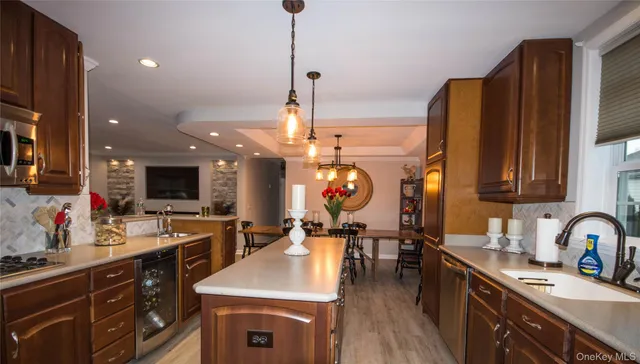 a kitchen with stainless steel appliances a sink stove and cabinets