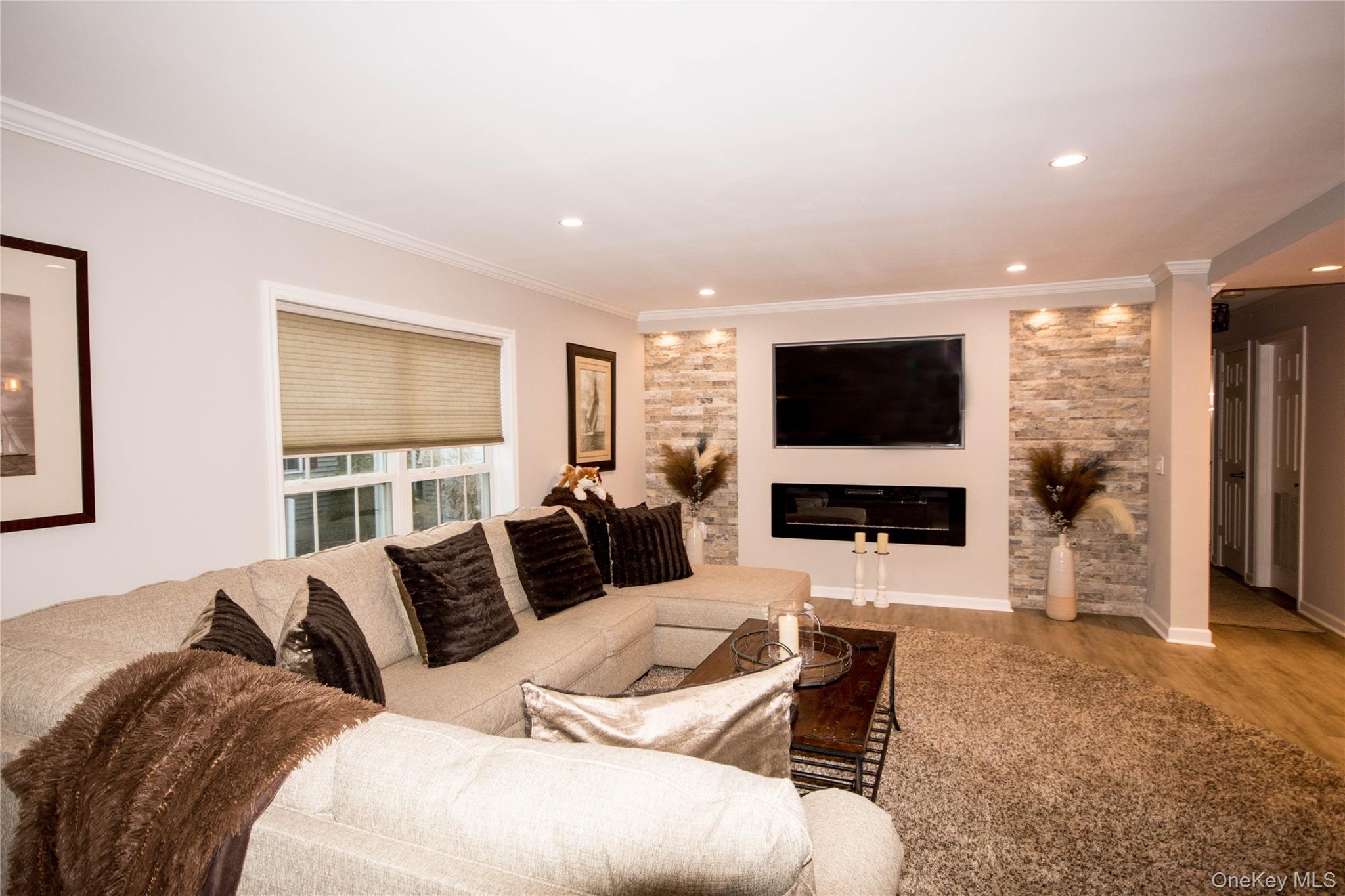 1661-519 Old Country Road, Unit 519 Riverhead, NY 11901 - Photo 4 of 17 a living room with furniture and a flat screen tv