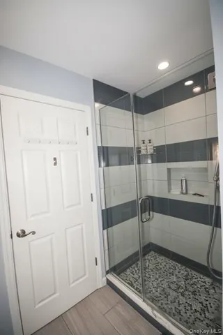 a bathroom with a glass shower door