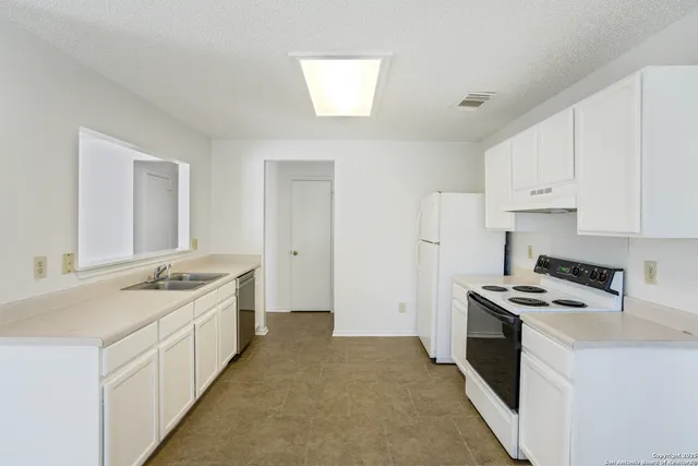 a kitchen with stainless steel appliances granite countertop a stove and a refrigerator