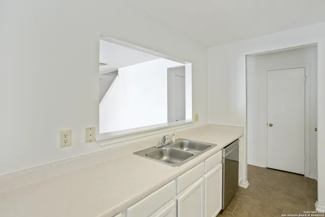 a bathroom with a sink and a window