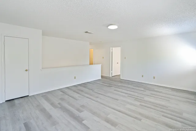 an empty room with wooden floor