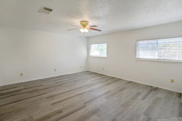 a view of a room with wooden floor and chandelier