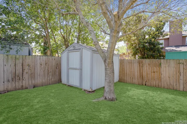 a view of a house with a yard and sitting area