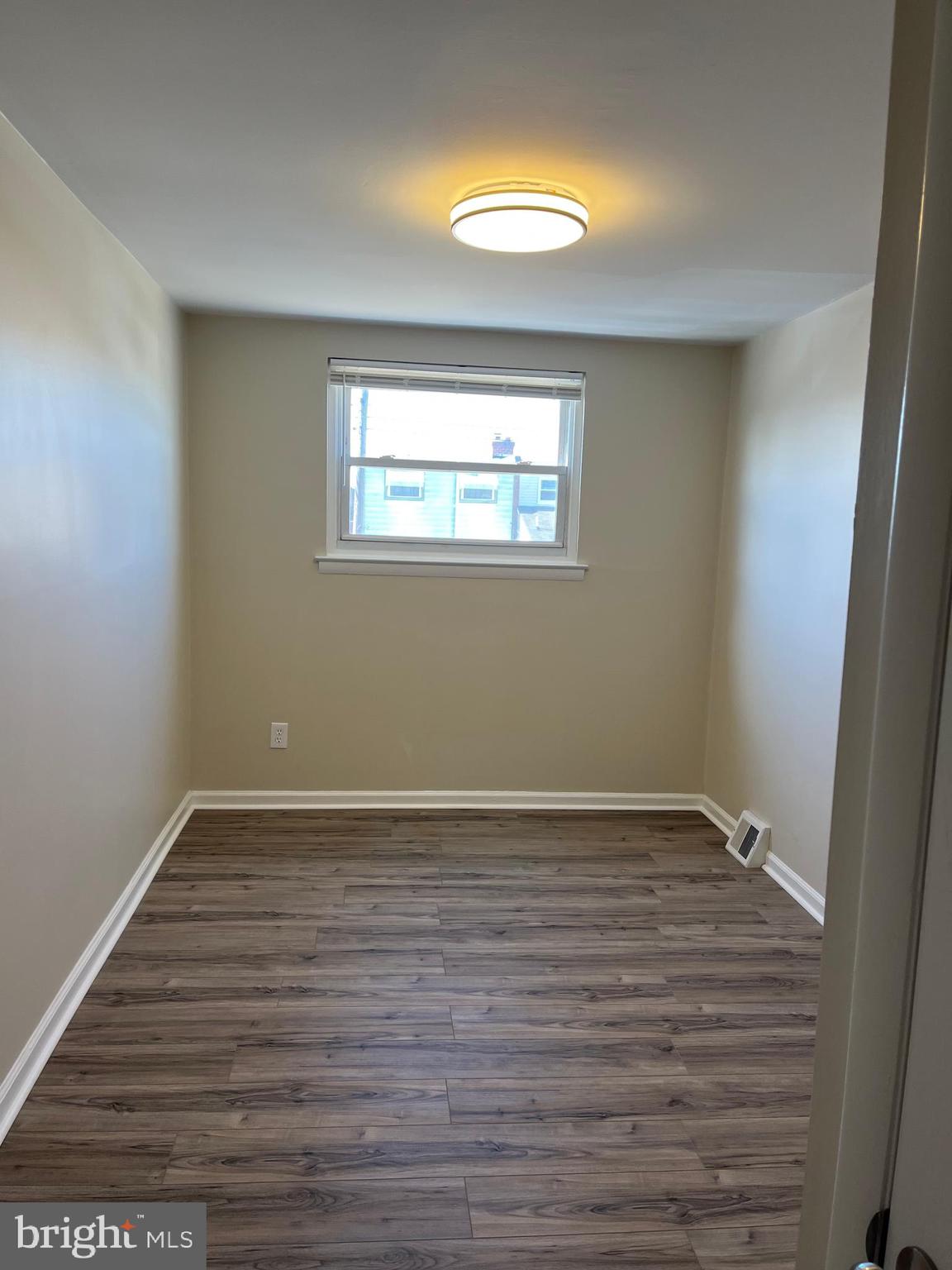 3464 Fitler Street Philadelphia, PA 19114 - Photo 14 of 22 a view of an empty room with wooden floor and a window