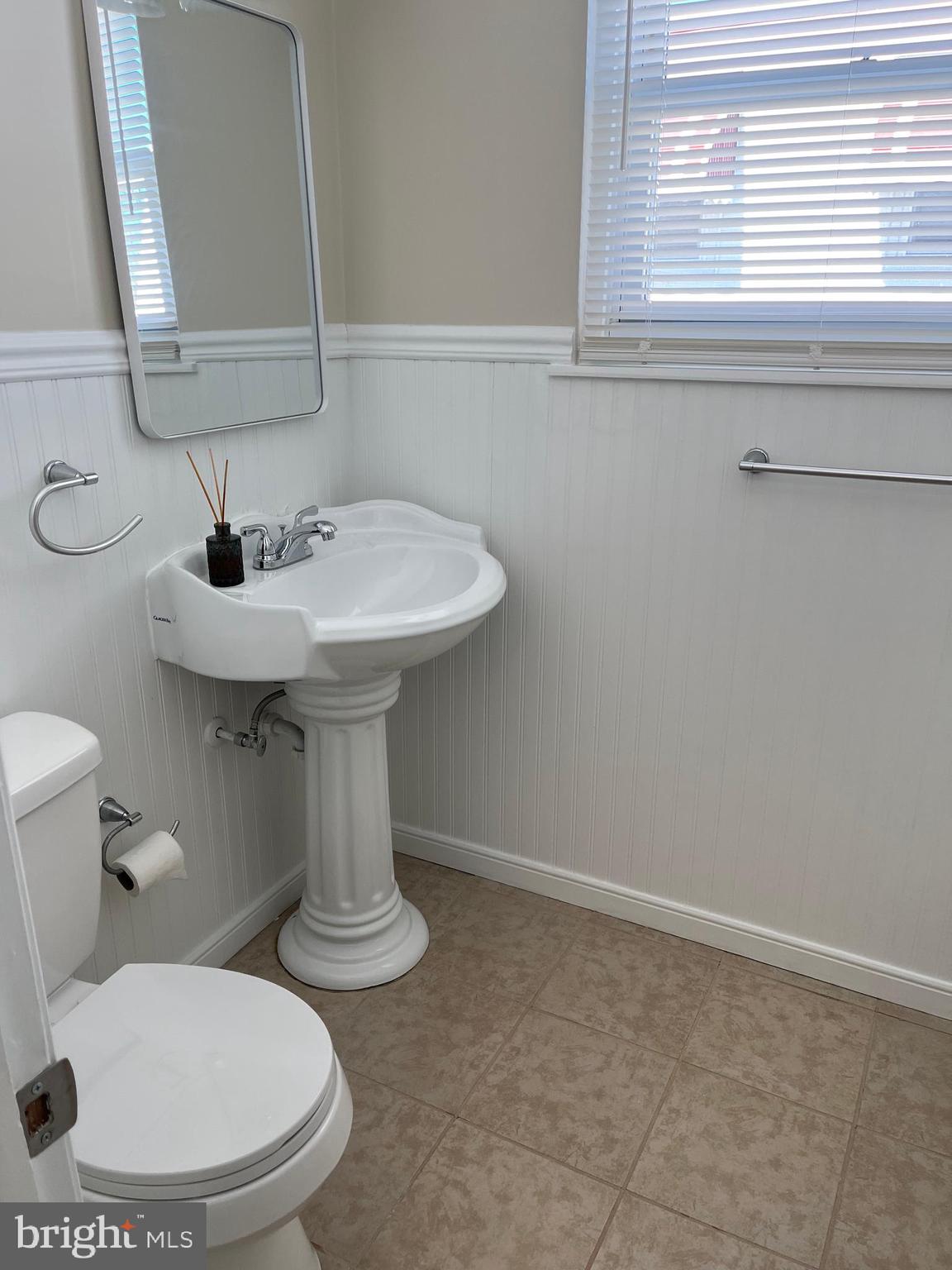 3464 Fitler Street Philadelphia, PA 19114 - Photo 18 of 22 a bathroom with a sink a toilet and mirror
