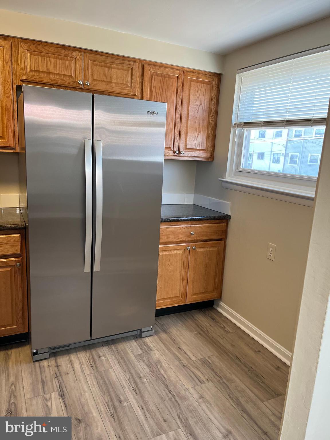 3464 Fitler Street Philadelphia, PA 19114 - Photo 7 of 22 a kitchen with stainless steel appliances wooden cabinets a refrigerator and a window