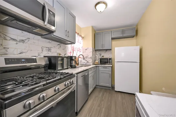 a kitchen with a stove and a refrigerator