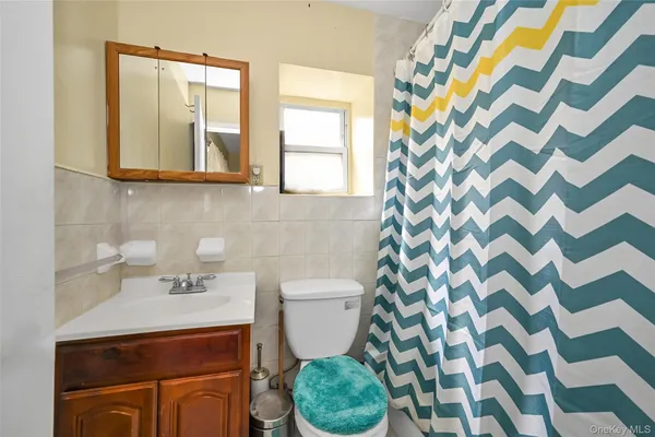 a bathroom with a sink toilet and mirror