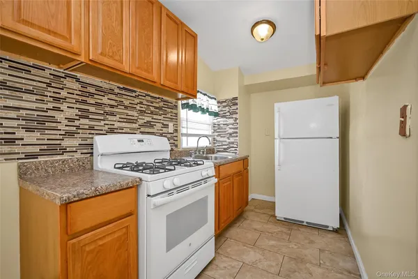 a kitchen with a stove top oven and refrigerator
