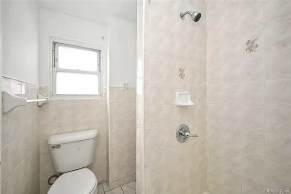 a white toilet sitting next to a bathroom sink