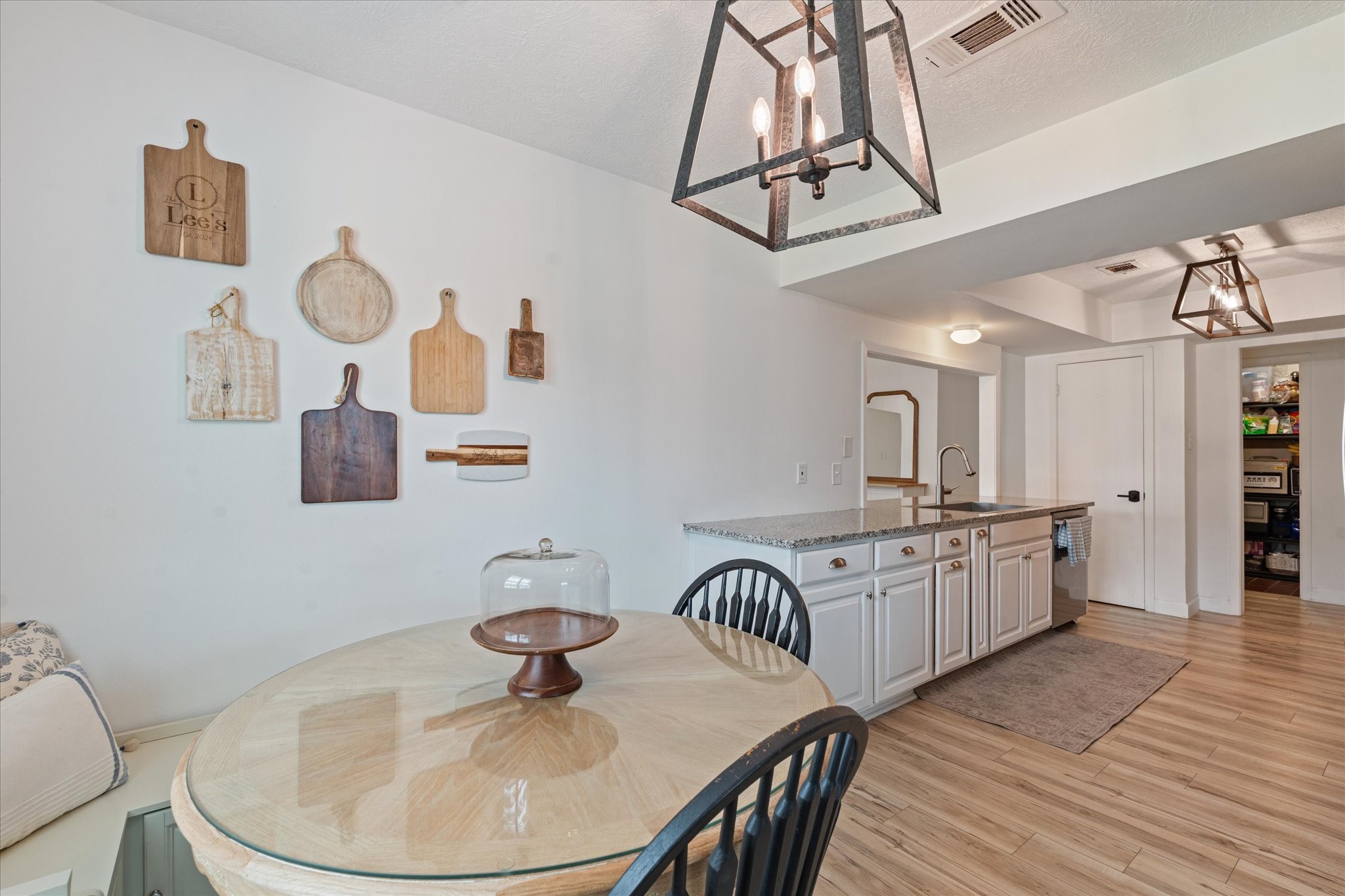 110 Dozent Lane Baytown, TX 77521 - Photo 10 of 36 a kitchen with stainless steel appliances granite countertop a sink a stove a dining table and chairs with wooden floor