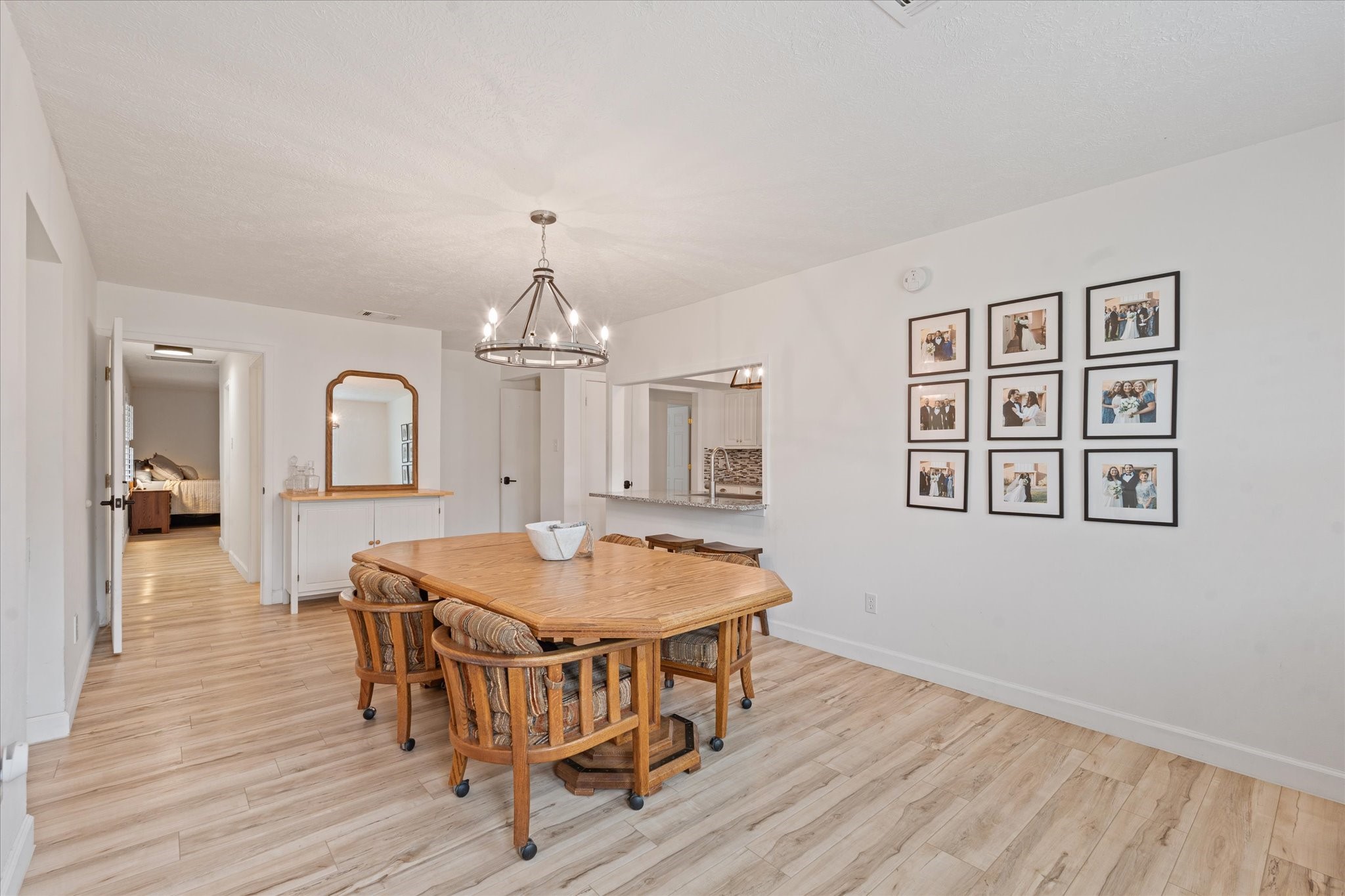 110 Dozent Lane Baytown, TX 77521 - Photo 13 of 36 a dining room with wooden floor a chandelier a wooden table and chairs
