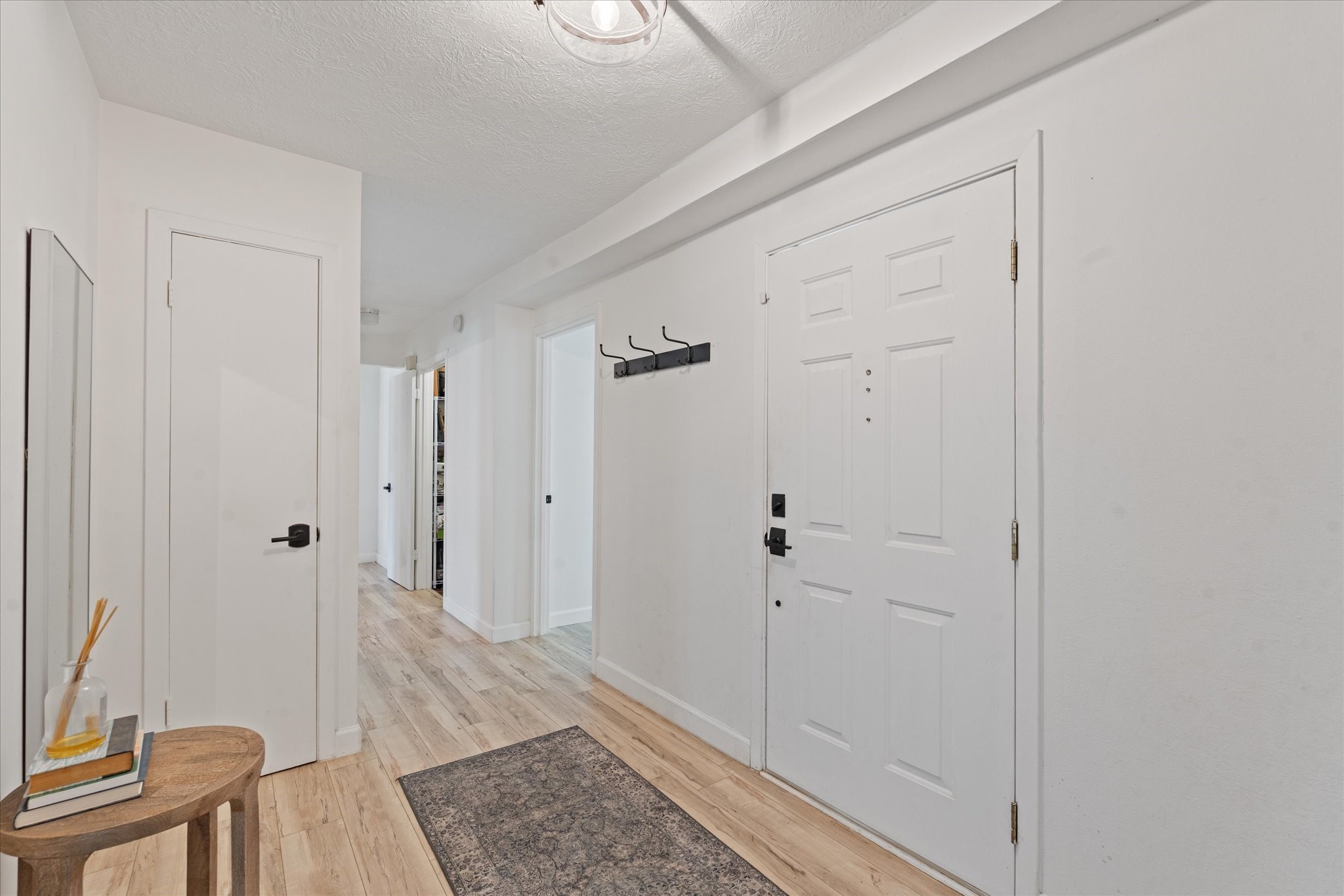 110 Dozent Lane Baytown, TX 77521 - Photo 4 of 36 a view of a hallway with wooden floor and a livingroom