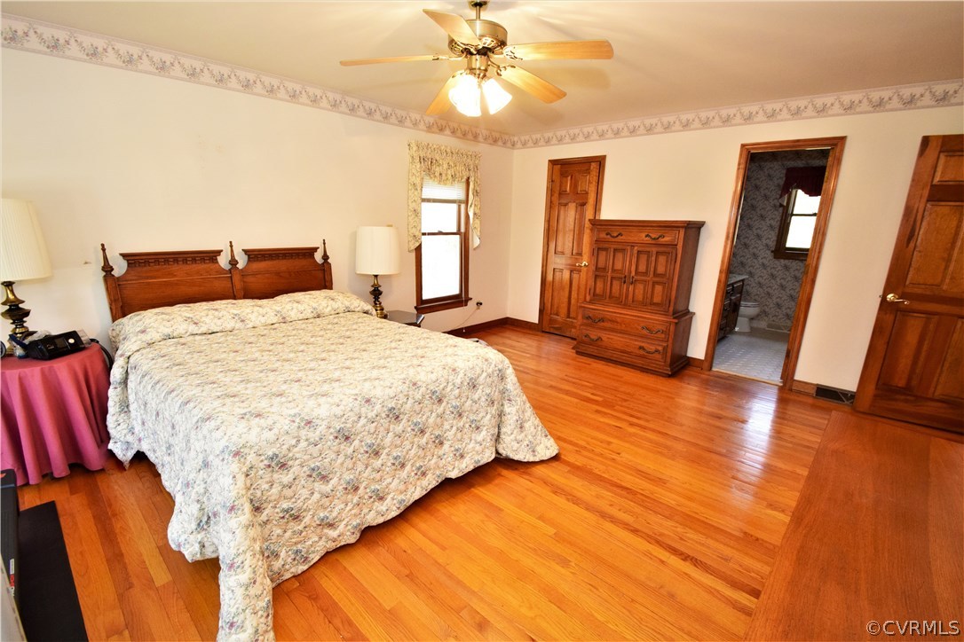 11101 Erin Road Chester, VA 23831 - Photo 19 of 46 a spacious bedroom with a bed and a chandelier