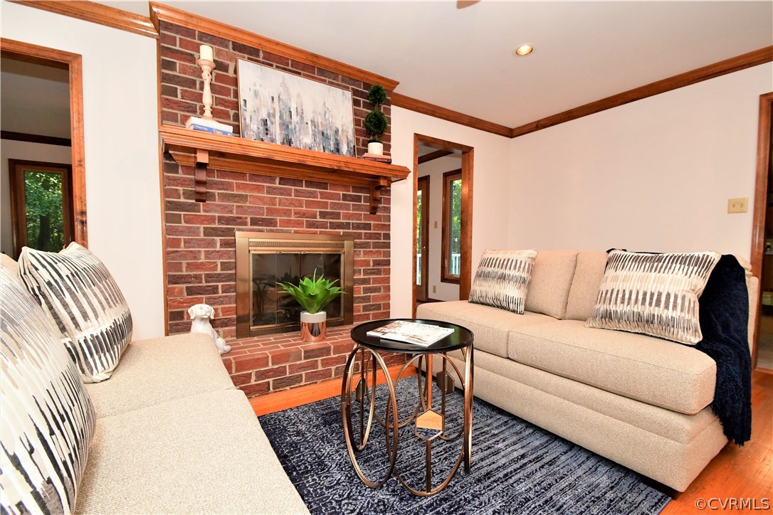 11101 Erin Road Chester, VA 23831 - Photo 6 of 46 a living room with furniture a fireplace and a floor to ceiling window