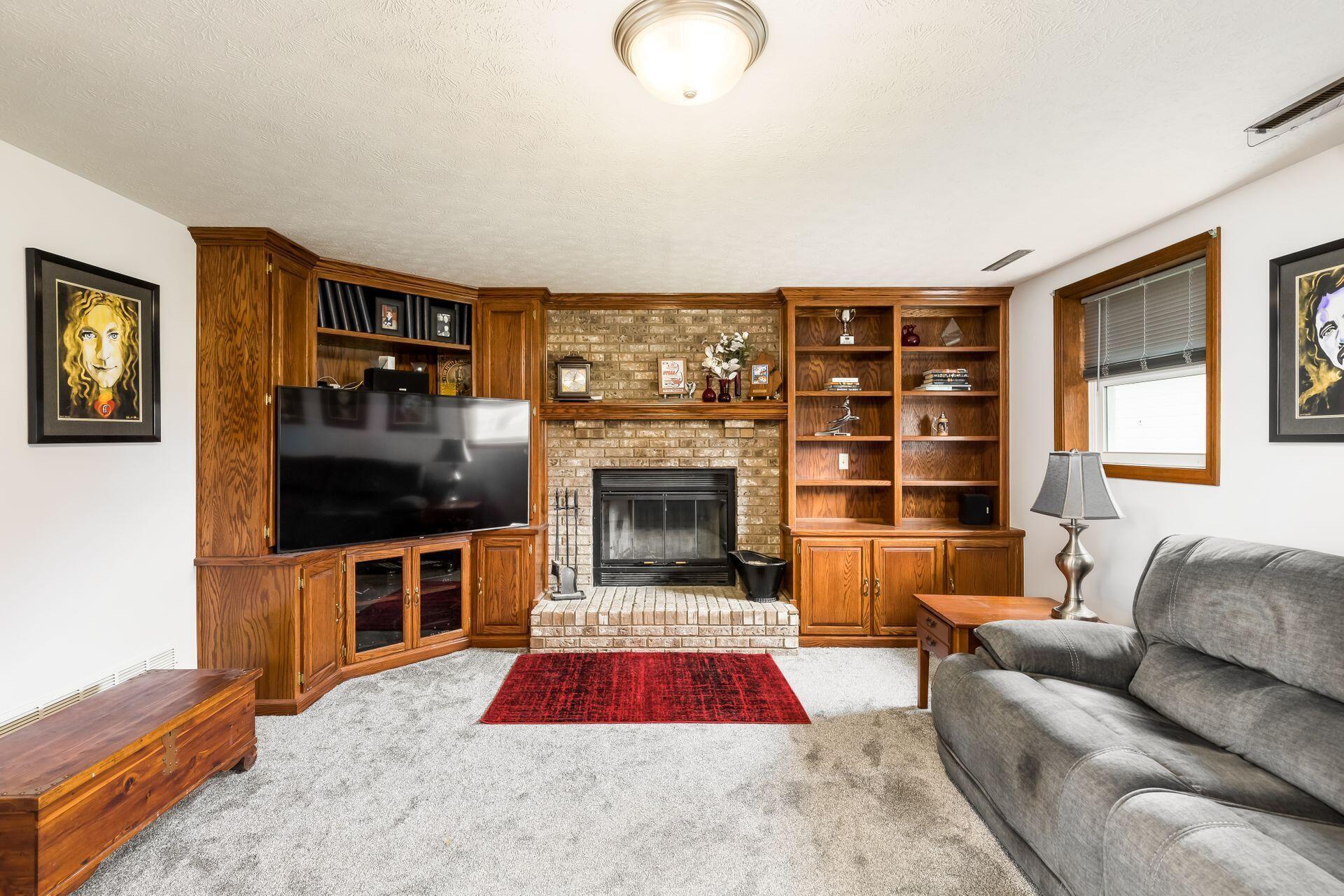 1710 Buttermilk Hill Road Delaware, OH 43015 - Photo 31 of 59 Built-in bookcases surround woodburning fireplace.