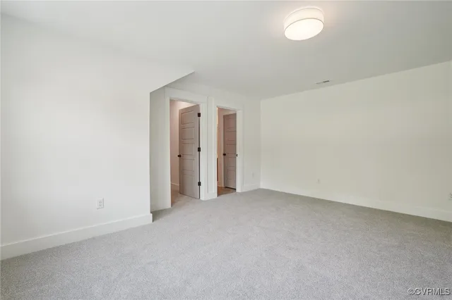 a view of empty room with fireplace and windows