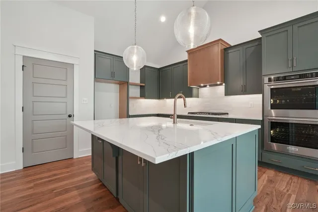 a kitchen with a sink cabinets and wooden floor
