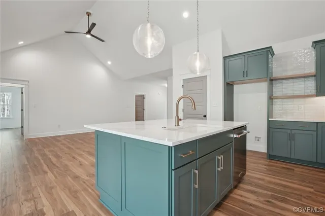 a kitchen with sink cabinets and wooden floor