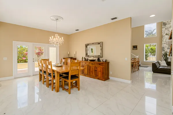 a large white kitchen with a stove a sink a window and a rug