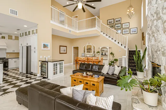a large white kitchen with a stove a sink a window and a rug