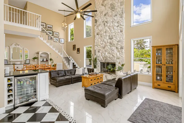 a kitchen with granite countertop stainless steel appliances a stove a sink a counter top space and a center island