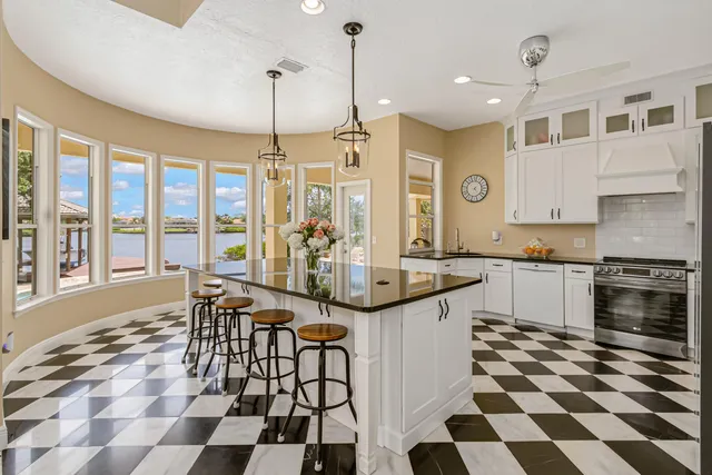 a living room with furniture and large windows