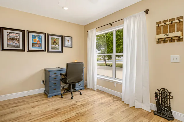 a view of a room with wooden floor and a window