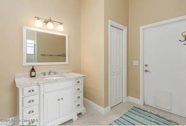 a bathroom with a double vanity sink mirror double and bathtub