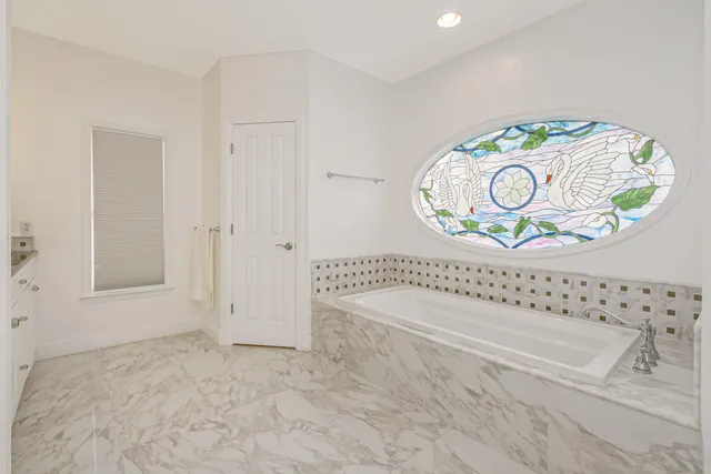 a spacious bedroom with a bed and a window