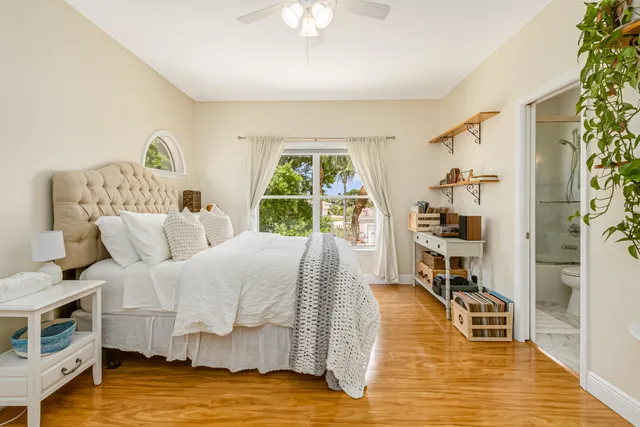 a view of swimming pool with lawn chairs and plants