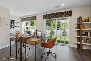 a room with pool table and two windows