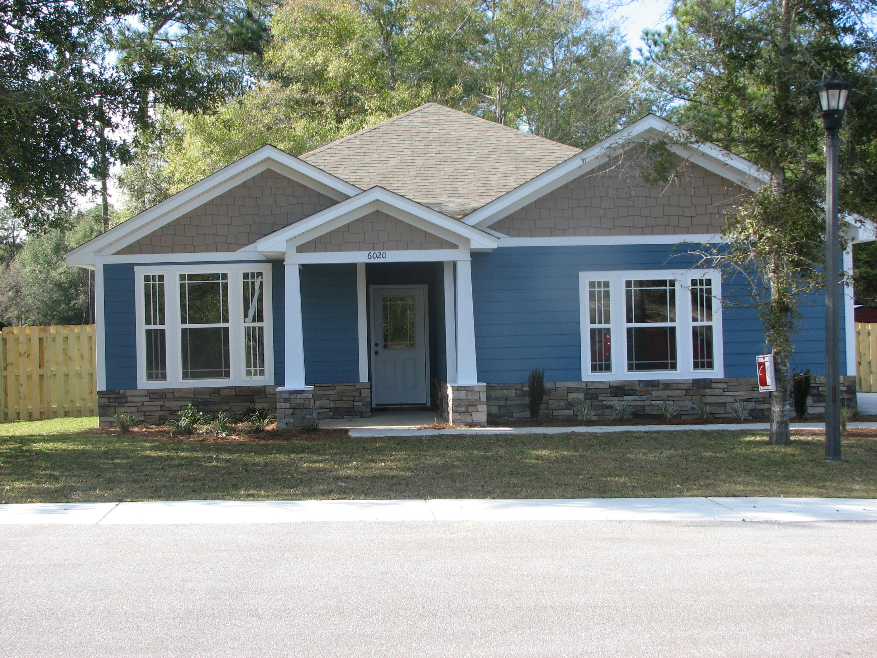 6020 Hidden Valley Road Crestview, FL 32539 - Photo 1 of 24 a front view of a house with a yard and garage