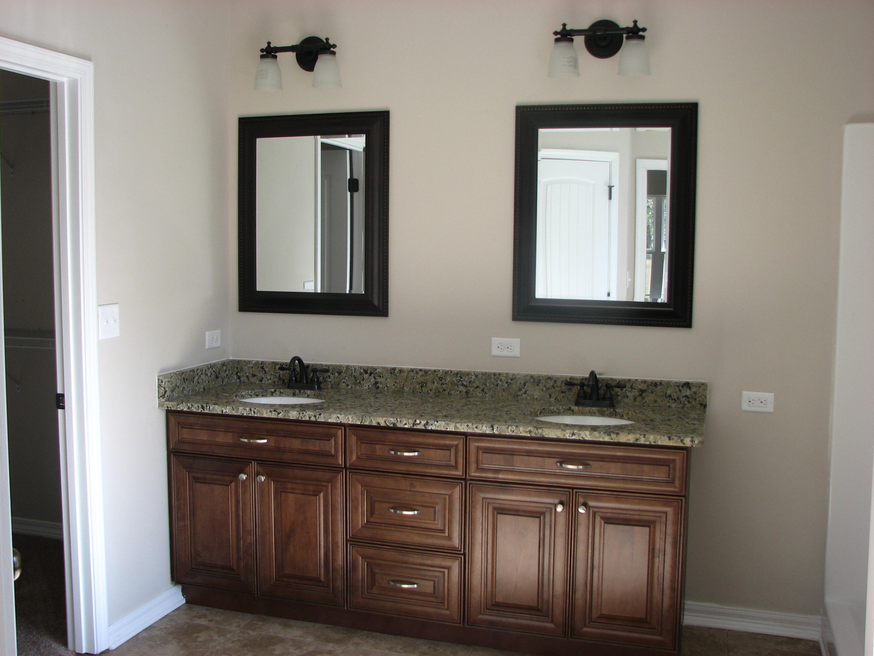 6020 Hidden Valley Road Crestview, FL 32539 - Photo 11 of 24 a bathroom with a granite countertop sink a mirror and cabinets