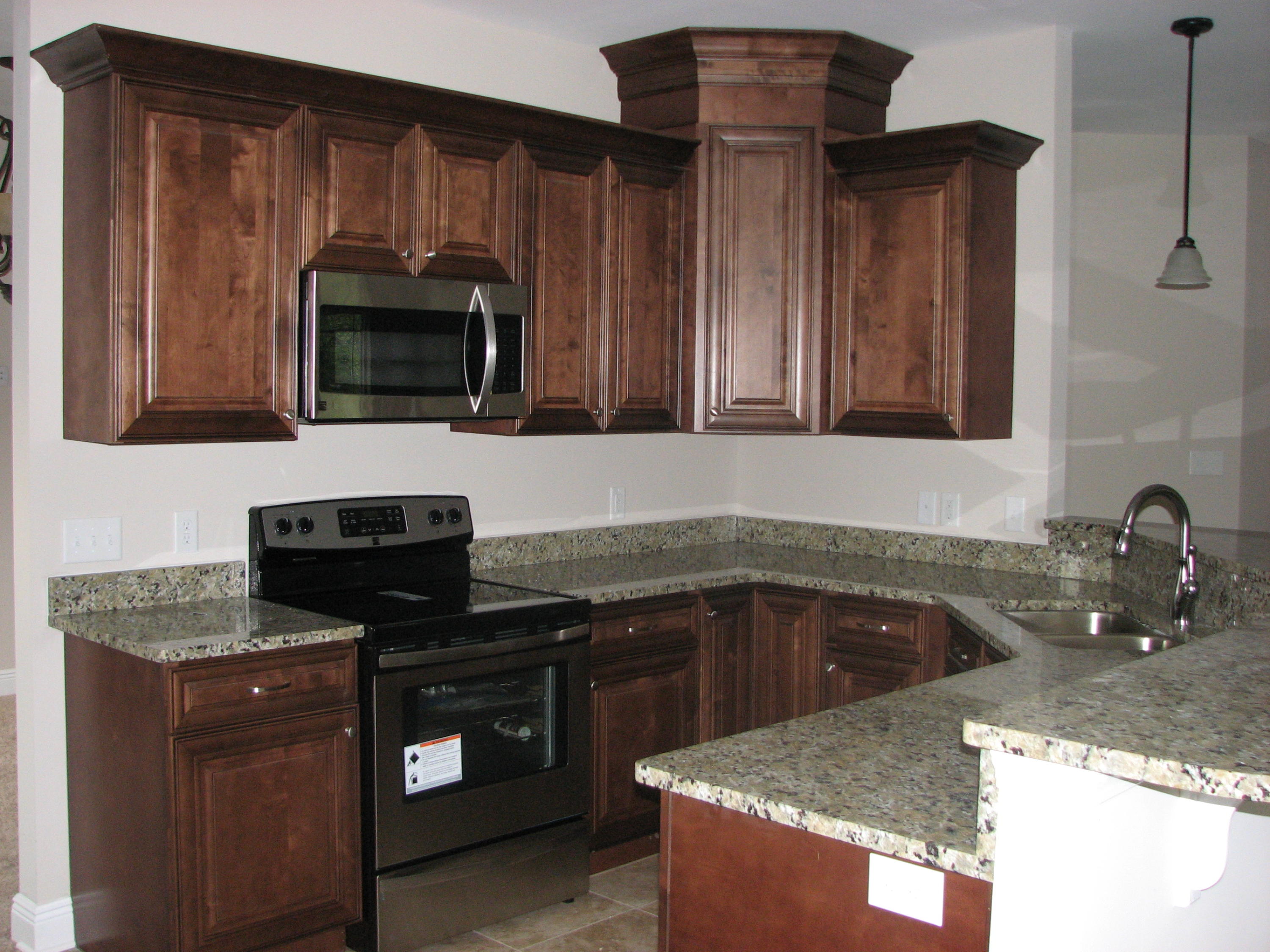 6020 Hidden Valley Road Crestview, FL 32539 - Photo 5 of 24 a kitchen with granite countertop a sink a stove and cabinets