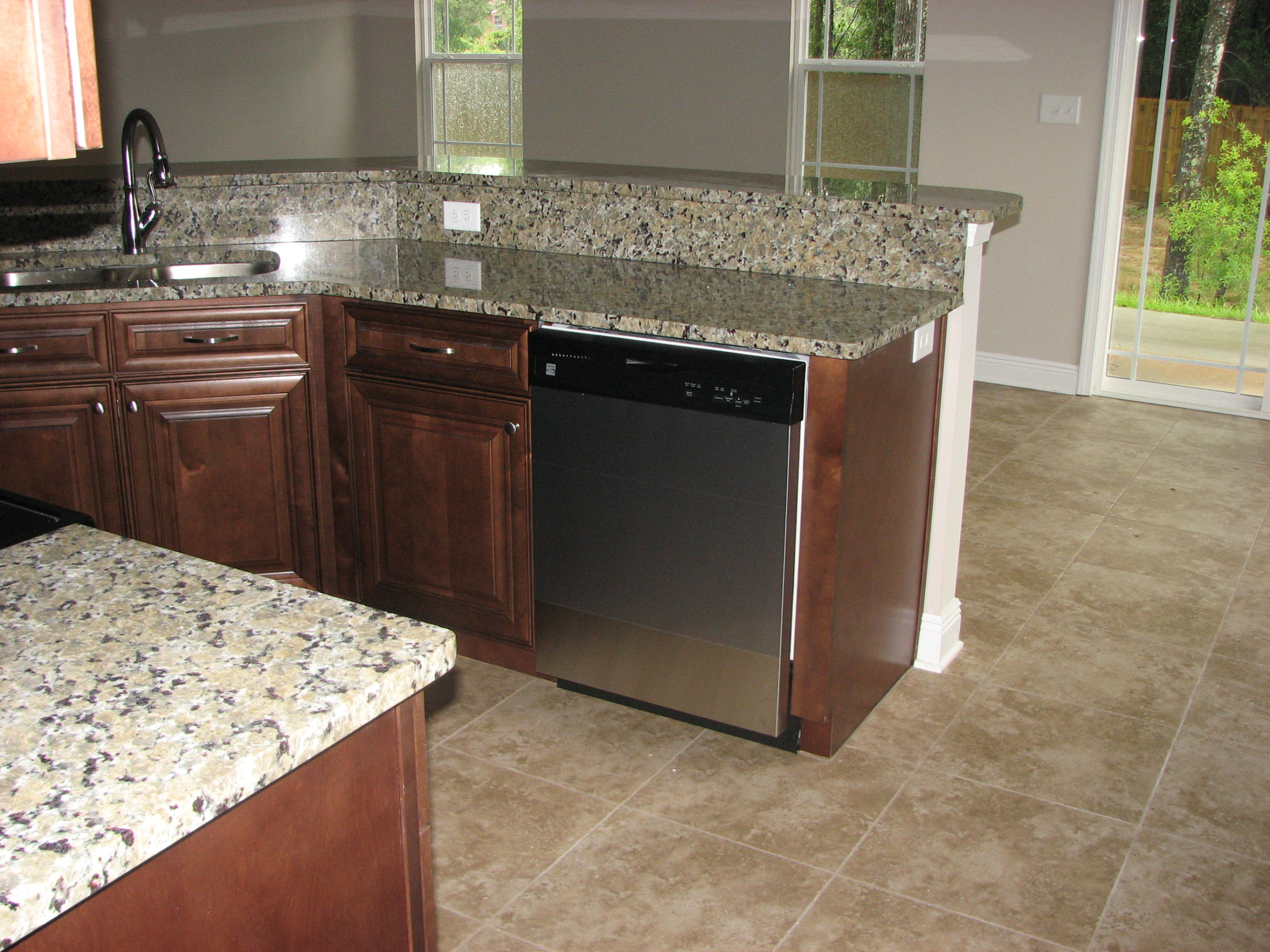 6020 Hidden Valley Road Crestview, FL 32539 - Photo 6 of 24 a kitchen with granite countertop a sink and a stove