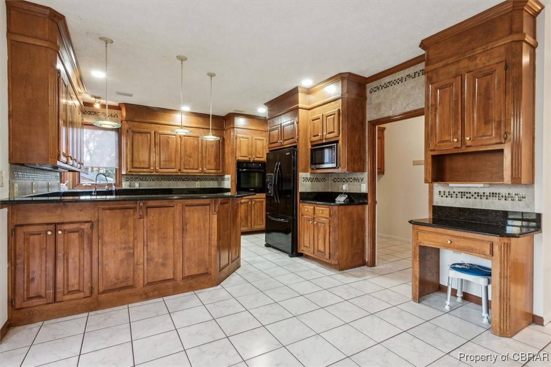 1318 Showalter Road Yorktown, VA 23692 - Photo 16 of 47 Kitchen with kitchen peninsula, crown molding, decorative light fixtures, light tile patterned floors, and black appliances