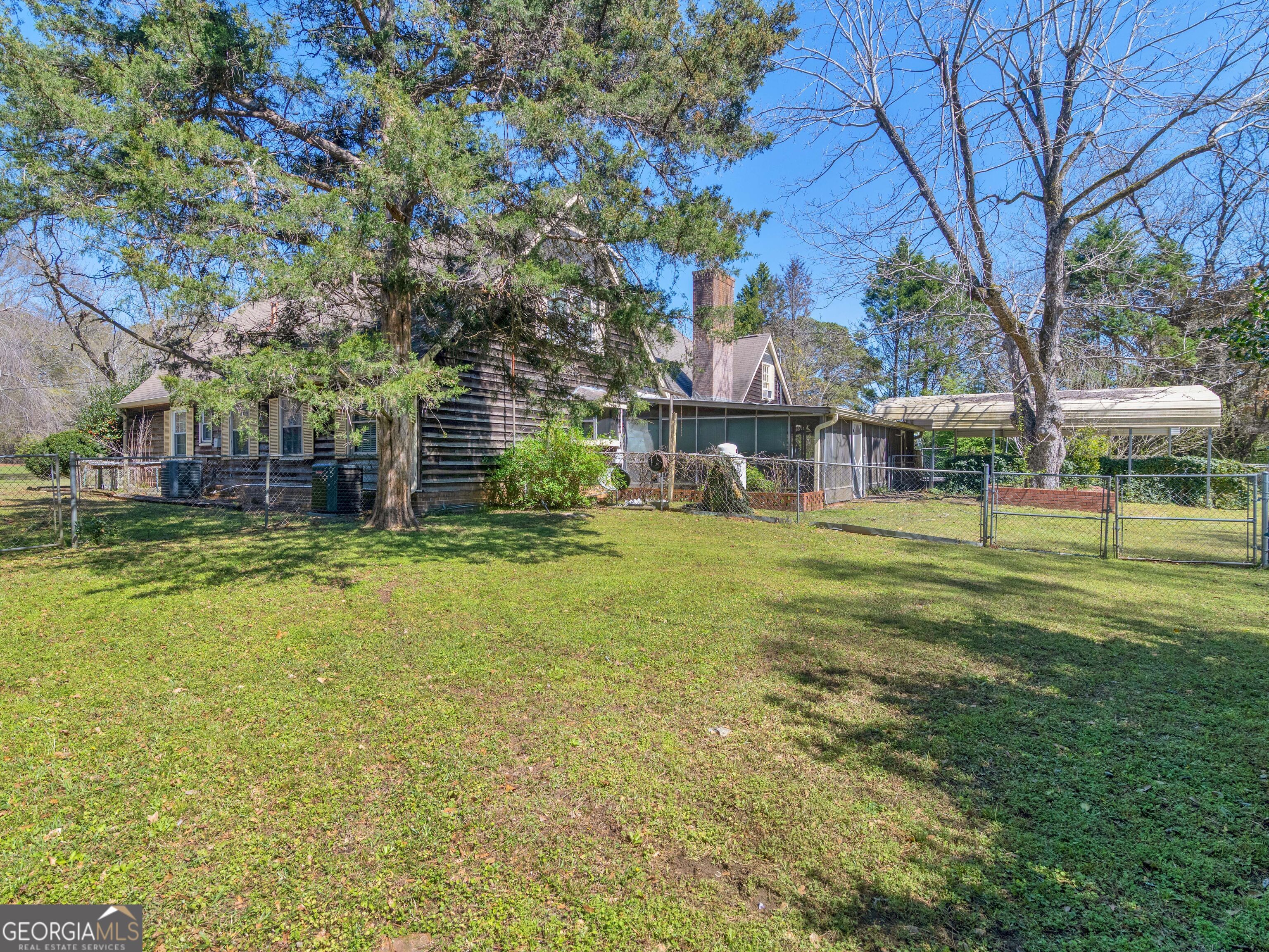 209 Founders Drive Barnesville, GA 30204 - Photo 11 of 80 a view of a house with a big yard and large trees