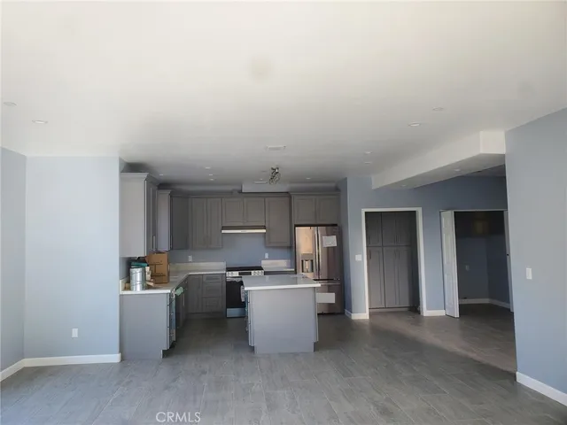 a kitchen that has a sink cabinets counter space and appliances
