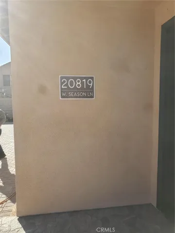 a view of empty room with wooden floor and chair